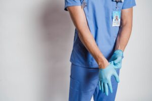 male doctor putting on sterile gloves