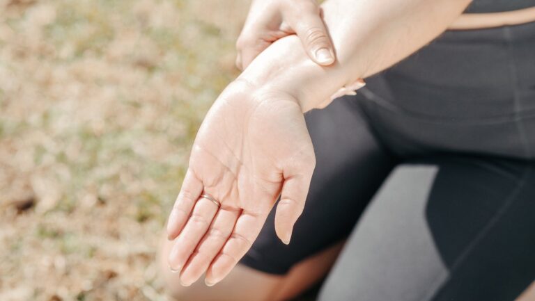 close up photo of a woman stretching her wrist