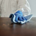 close up photo of person cleaning the table